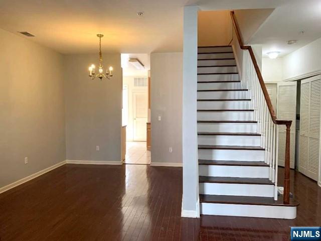 201 Dey Street, Unit 162 Harrison, NJ 07029 - Photo 8 of 21 an empty room with wooden floor and windows