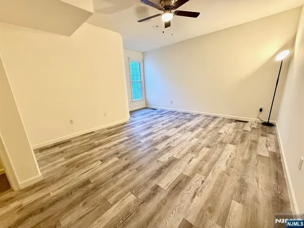 a view of a room with a wooden floor