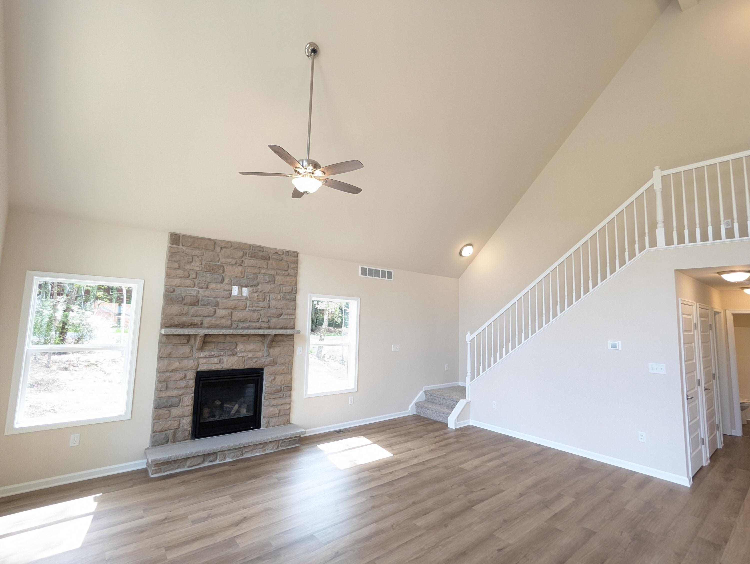 251 Bellingham Drive Bushkill, PA 18324 - Photo 3 of 53 a view of a livingroom with a fireplace a ceiling fan and wooden floor