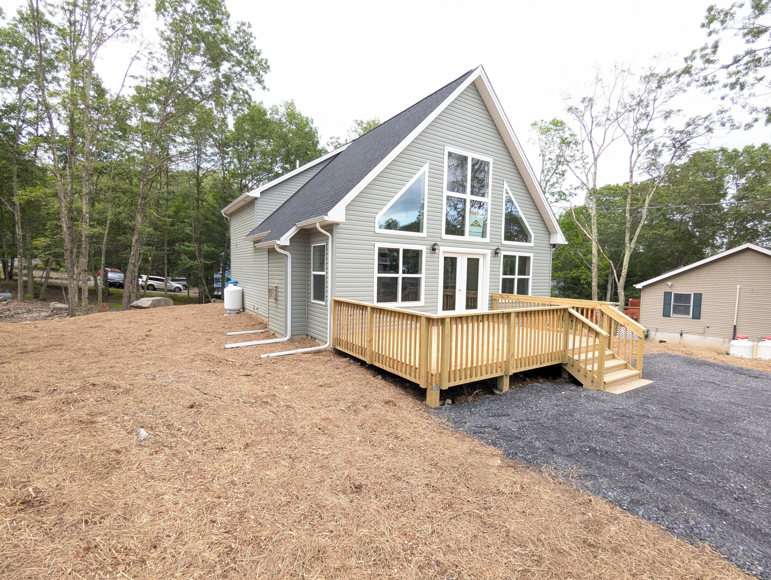 251 Bellingham Drive Bushkill, PA 18324 - Photo 37 of 53 a view of a house with a yard and large trees