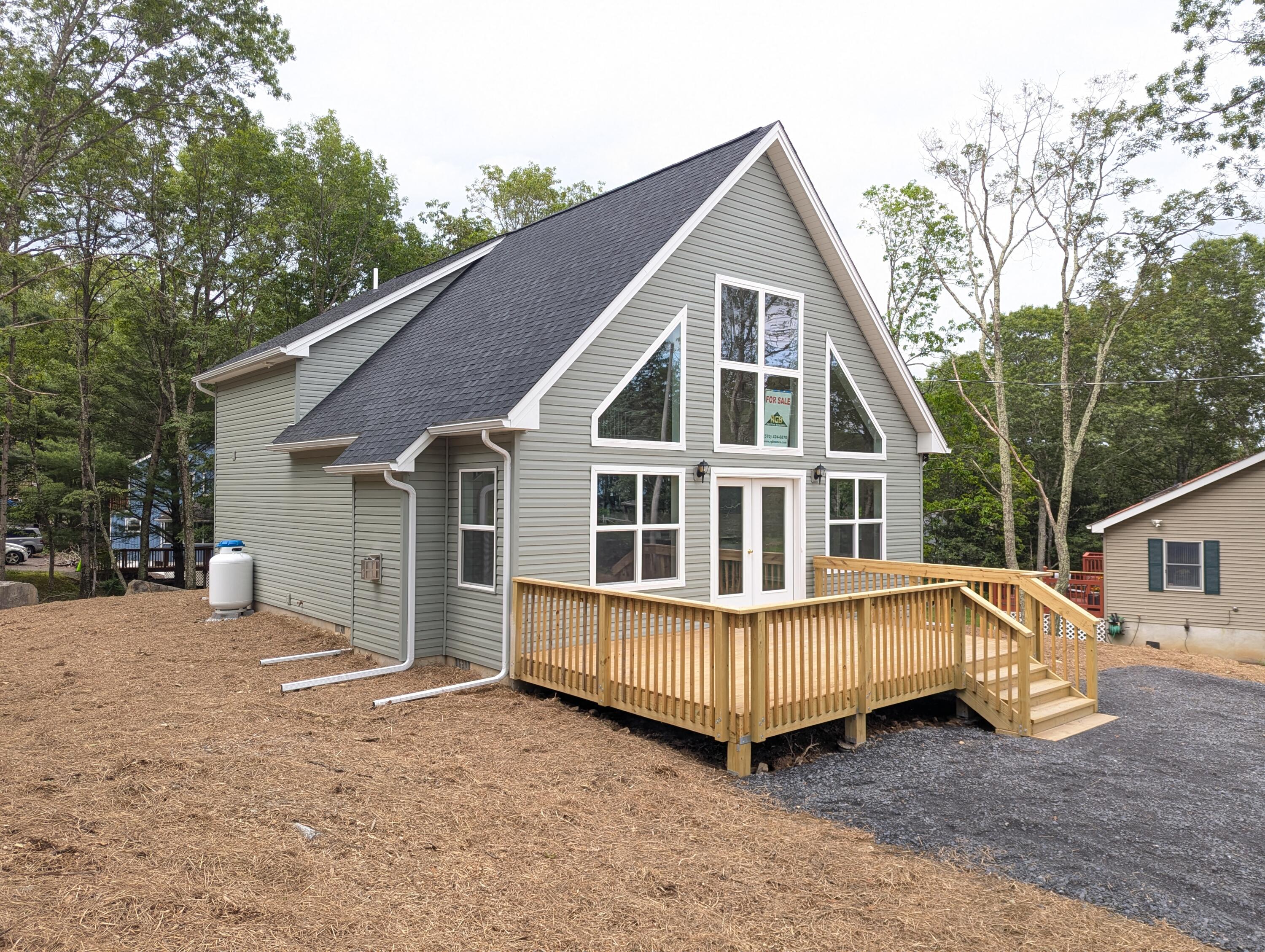 251 Bellingham Drive Bushkill, PA 18324 - Photo 38 of 53 a view of a house with a yard and deck area