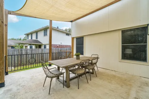 a view of a patio with a table and chairs and wooden floor