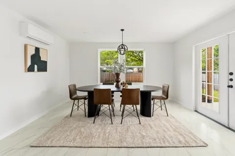 a view of a dining room with furniture window and outside view