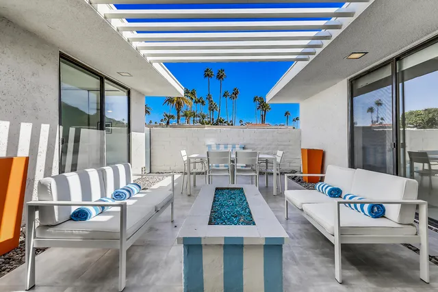 a outdoor space with a table and chairs