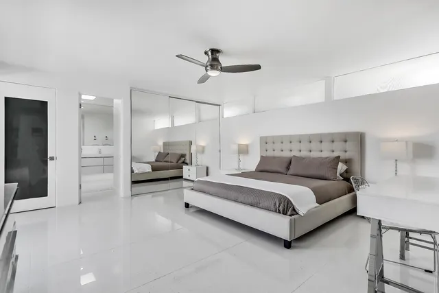 a bedroom with a bed and a night stand