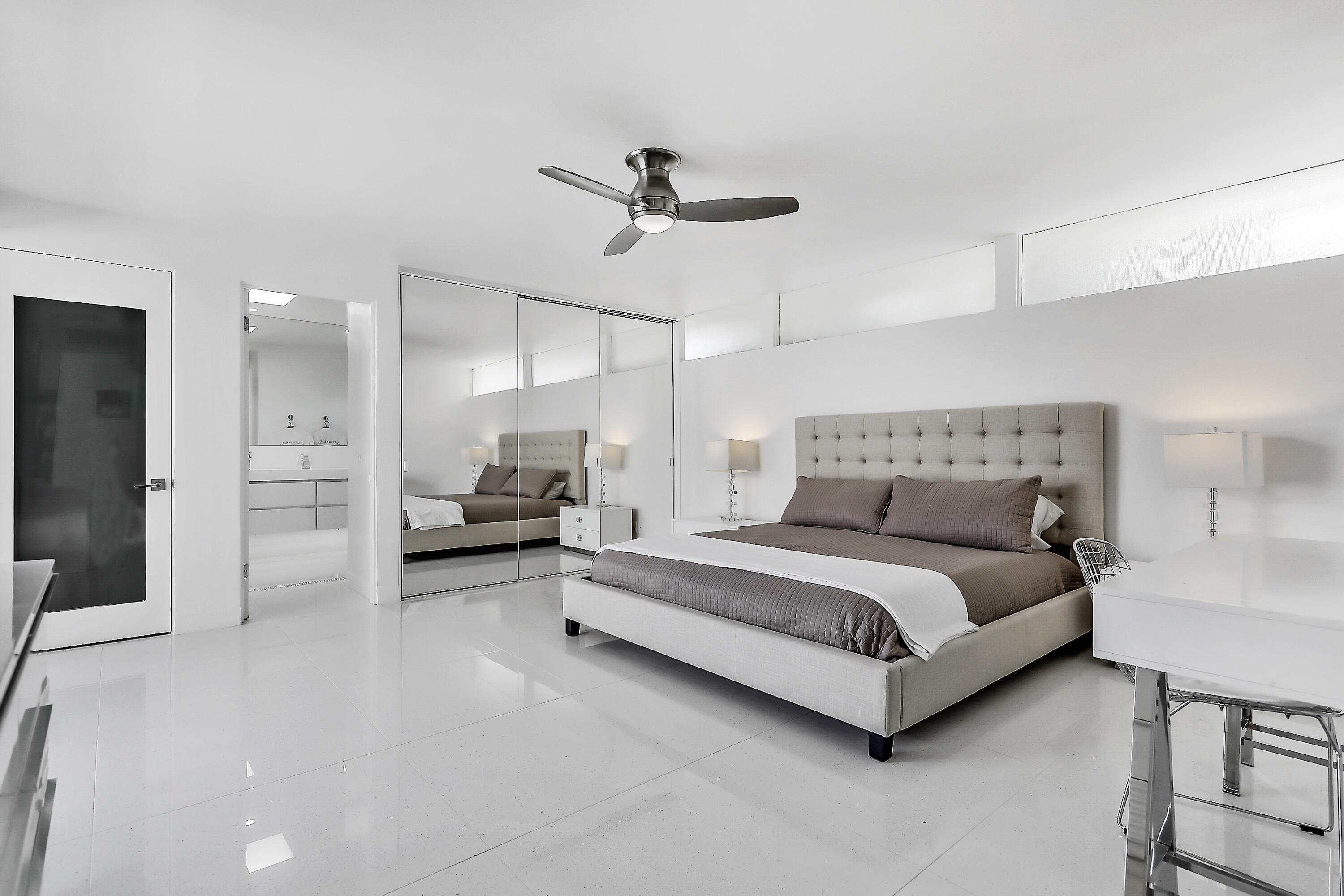 45765 Hopi Road Indian Wells, CA 92210 - Photo 17 of 39 a spacious bedroom with a bed a couch and a chandelier