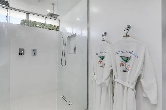 a bedroom with a large bed and a night stand