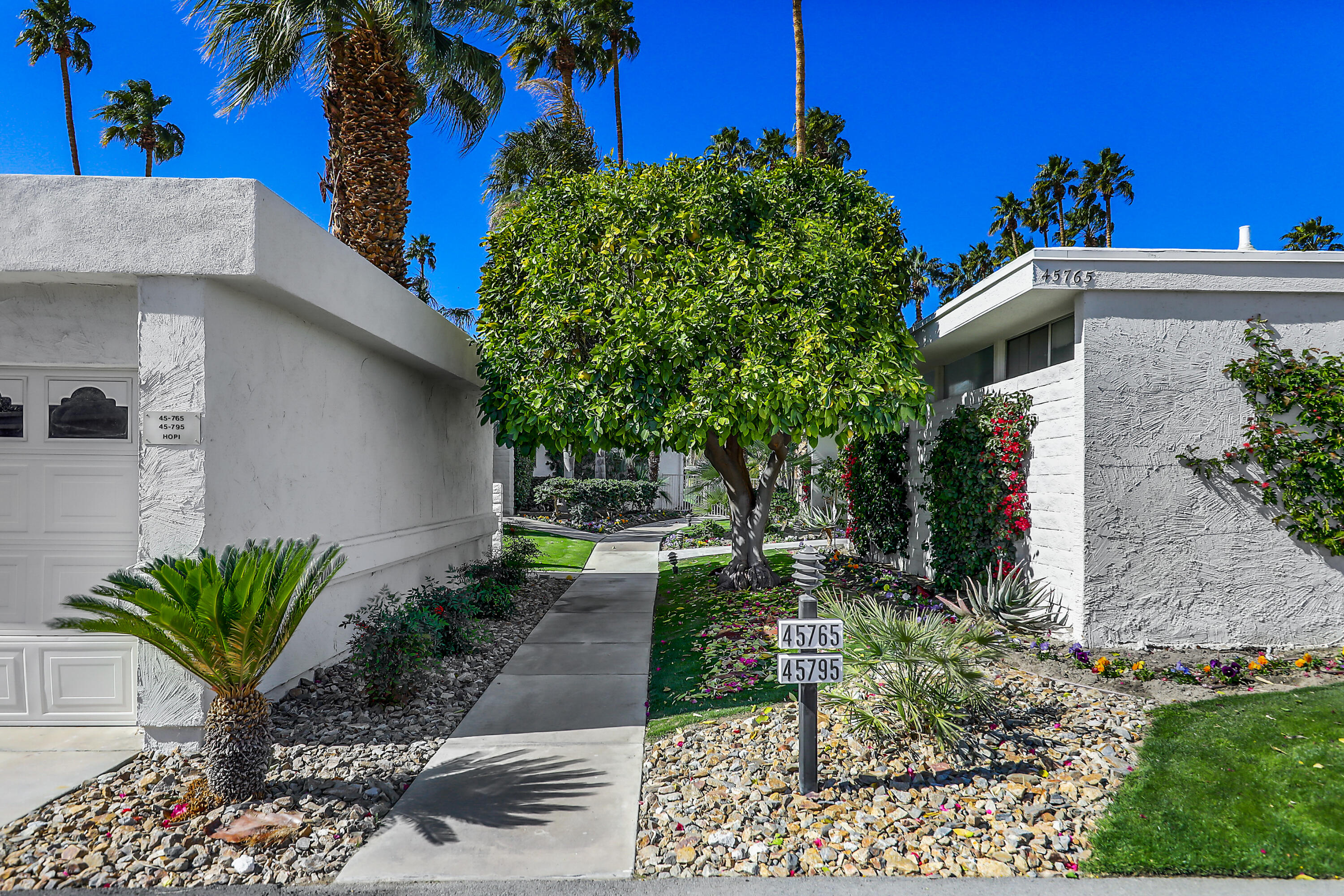 45765 Hopi Road Indian Wells, CA 92210 - Photo 31 of 39 a view of a house with a small yard and potted plants