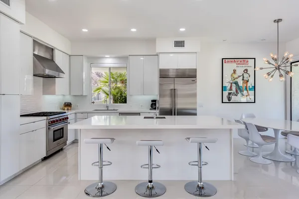 a kitchen with stainless steel appliances a stove and a sink