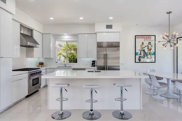 a kitchen with stainless steel appliances a stove and a sink