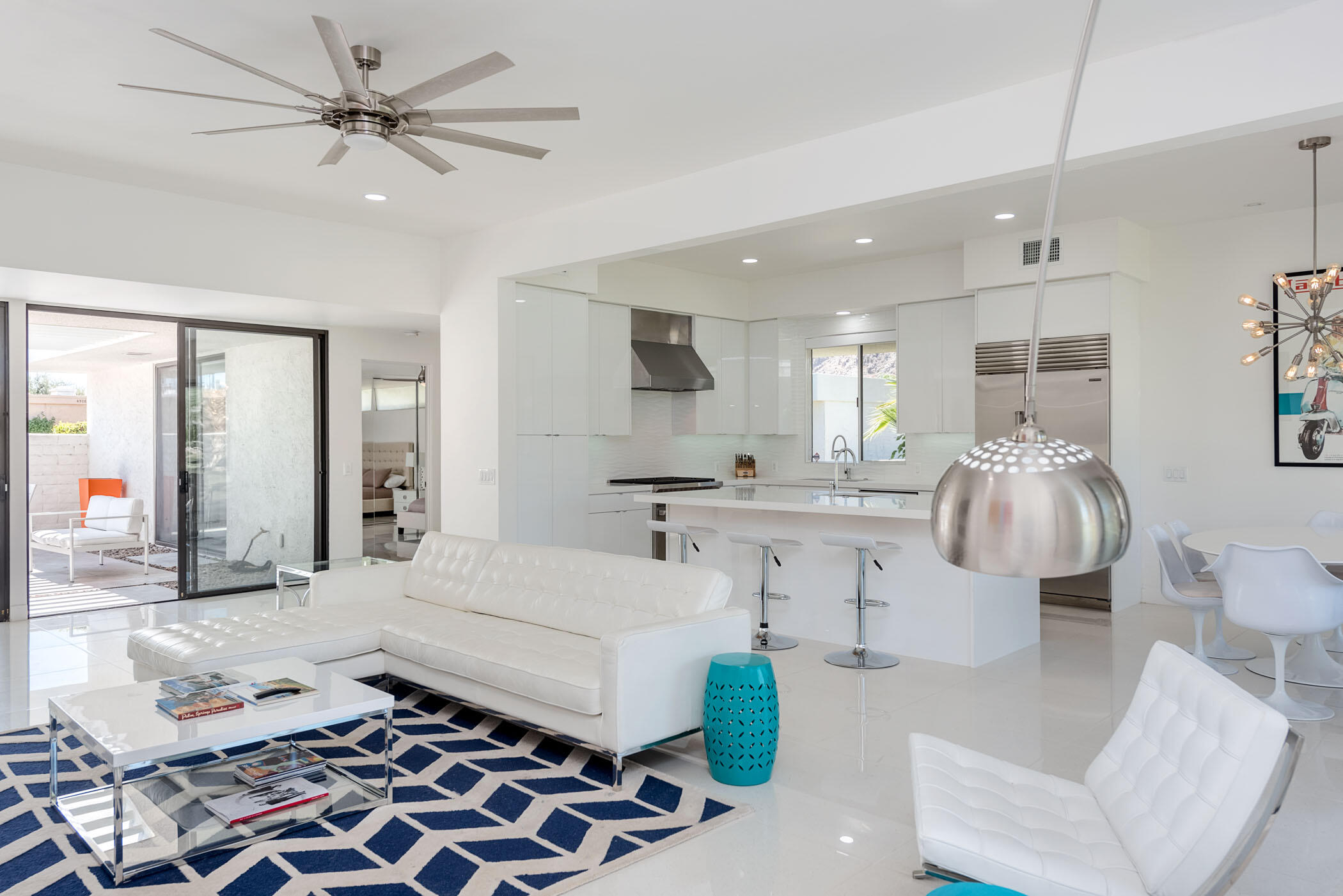 45765 Hopi Road Indian Wells, CA 92210 - Photo 9 of 39 a large white kitchen with a white countertops a stove and a chandelier