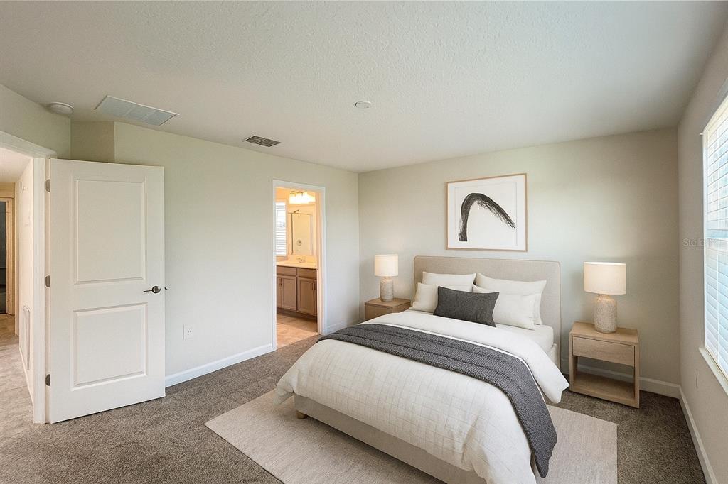 15216 Chapter Way Winter Garden, FL 34787 - Photo 14 of 53 a bedroom with a large bed and a window