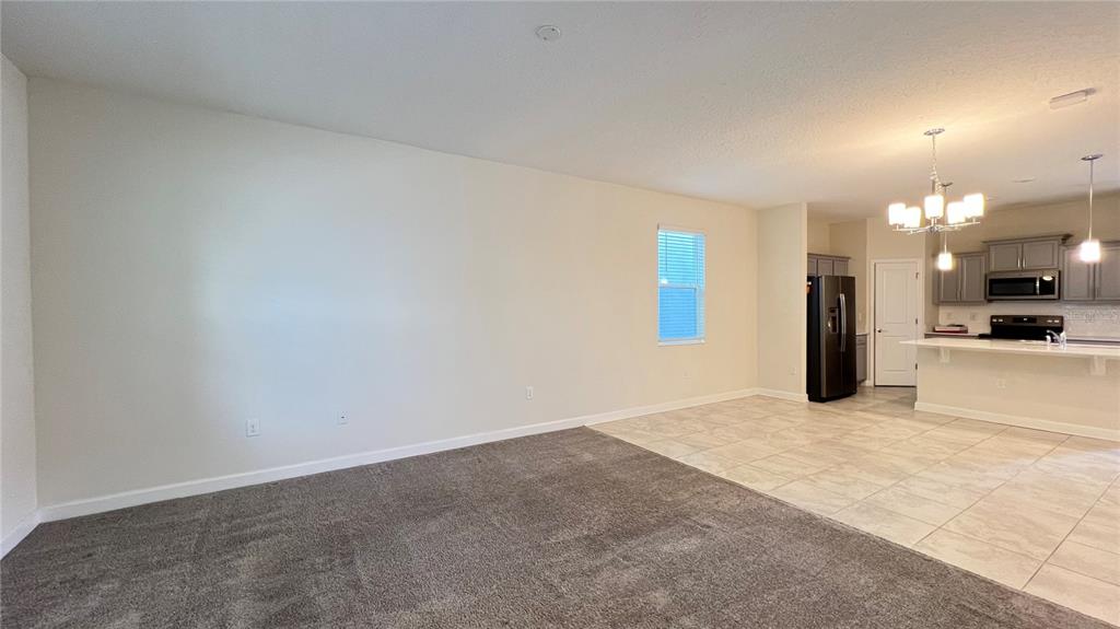 15216 Chapter Way Winter Garden, FL 34787 - Photo 20 of 53 a view of a kitchen with a refrigerator in a kitchen