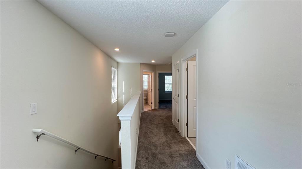15216 Chapter Way Winter Garden, FL 34787 - Photo 41 of 53 a view of a hallway with wooden floor