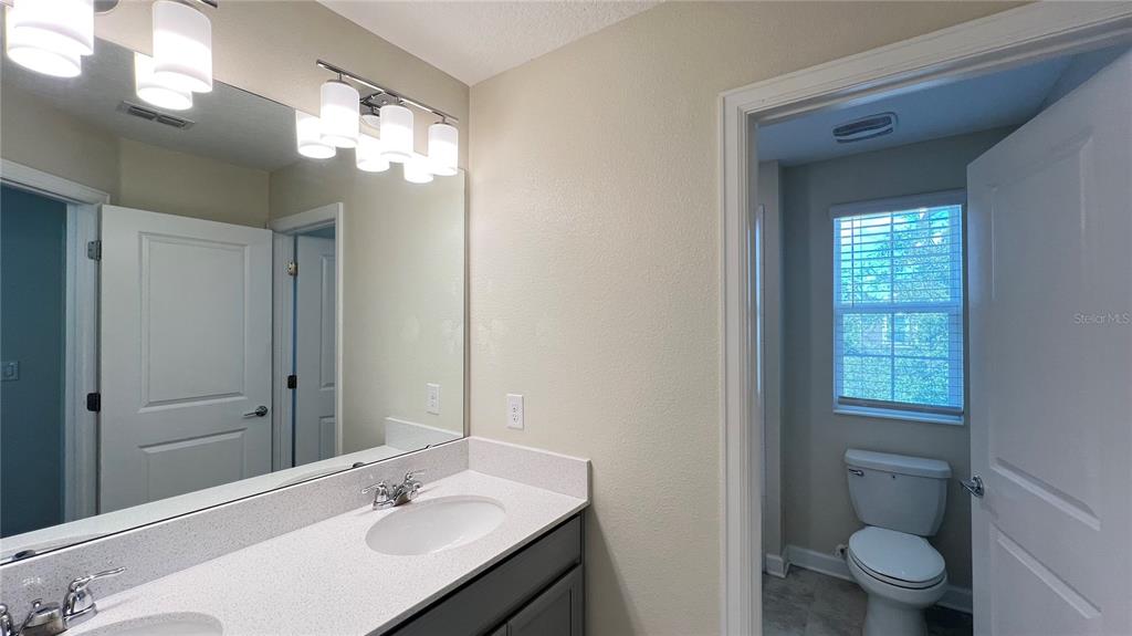 15216 Chapter Way Winter Garden, FL 34787 - Photo 53 of 53 a bathroom with a sink a toilet and a mirror