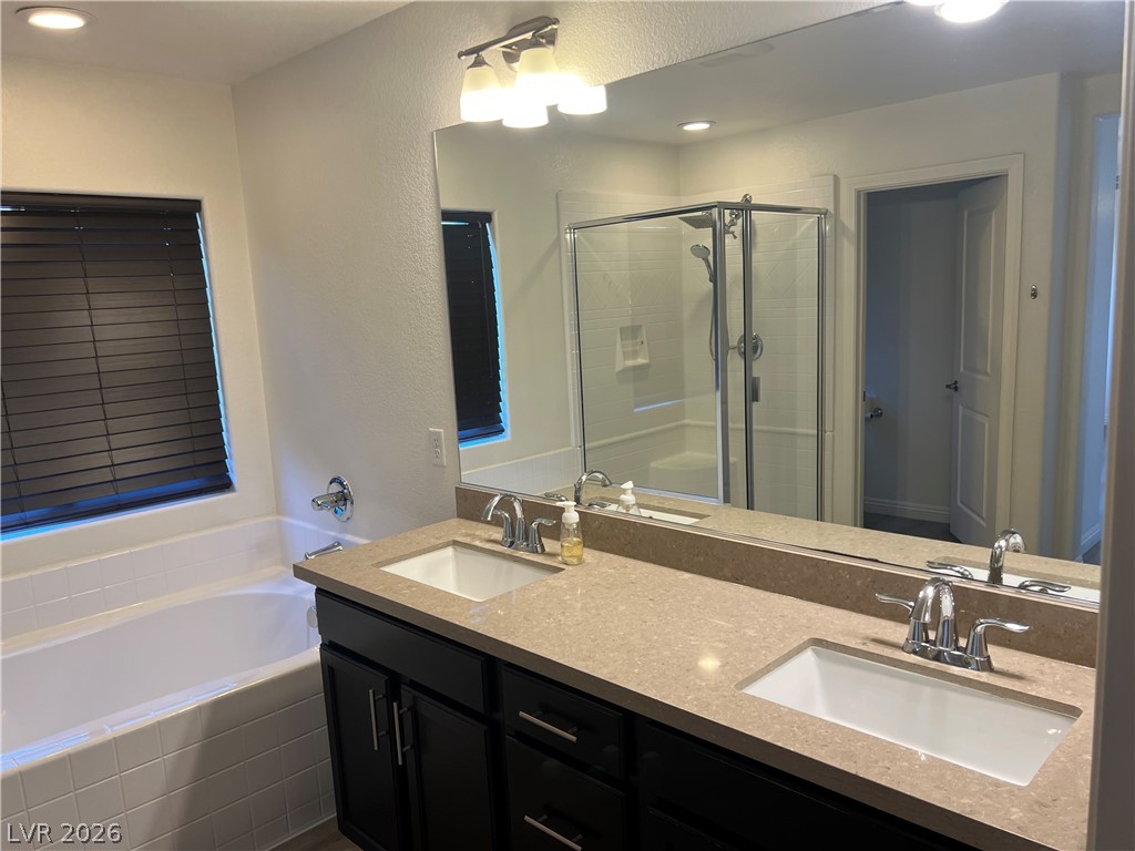 9581 Aberdeen Ridge Court Las Vegas, NV 89148 - Photo 24 of 25 A well-appointed primary bathroom showcases a dual vanity and a deep soaking tub, perfect for unwinding.