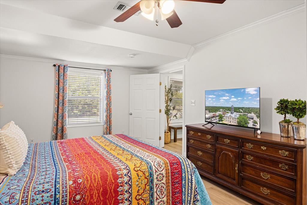310 West 6th Street Tolar, TX 76476 - Photo 9 of 27 a bedroom with a bed and a dresser