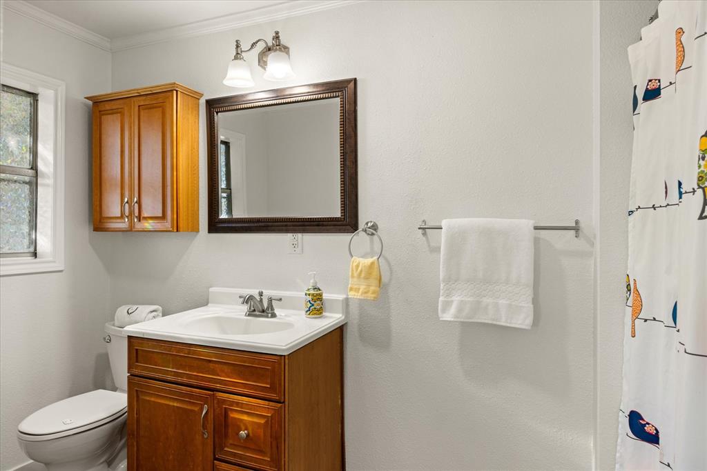 310 West 6th Street Tolar, TX 76476 - Photo 14 of 27 a bathroom with a sink toilet and mirror