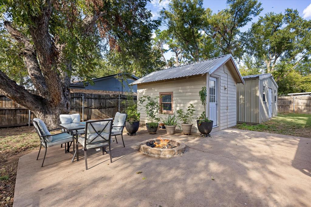 310 West 6th Street Tolar, TX 76476 - Photo 15 of 27 a view of backyard with table and chairs and a large tree