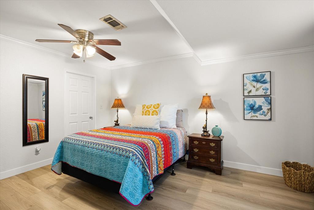 310 West 6th Street Tolar, TX 76476 - Photo 8 of 27 a bedroom with a bed and wooden floor