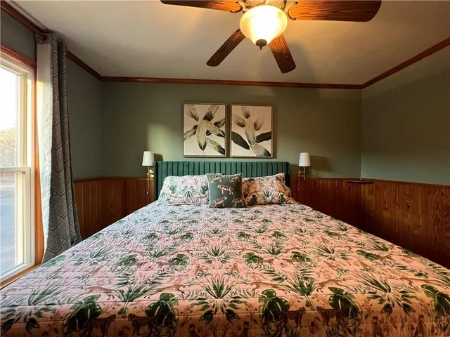 a bed sitting in a bedroom next to a window