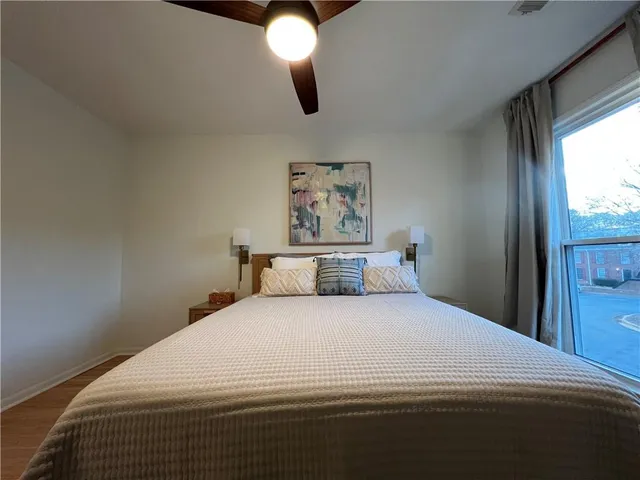 a bedroom with a large bed and a large window