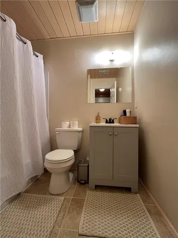 a bathroom with a sink a toilet and mirror