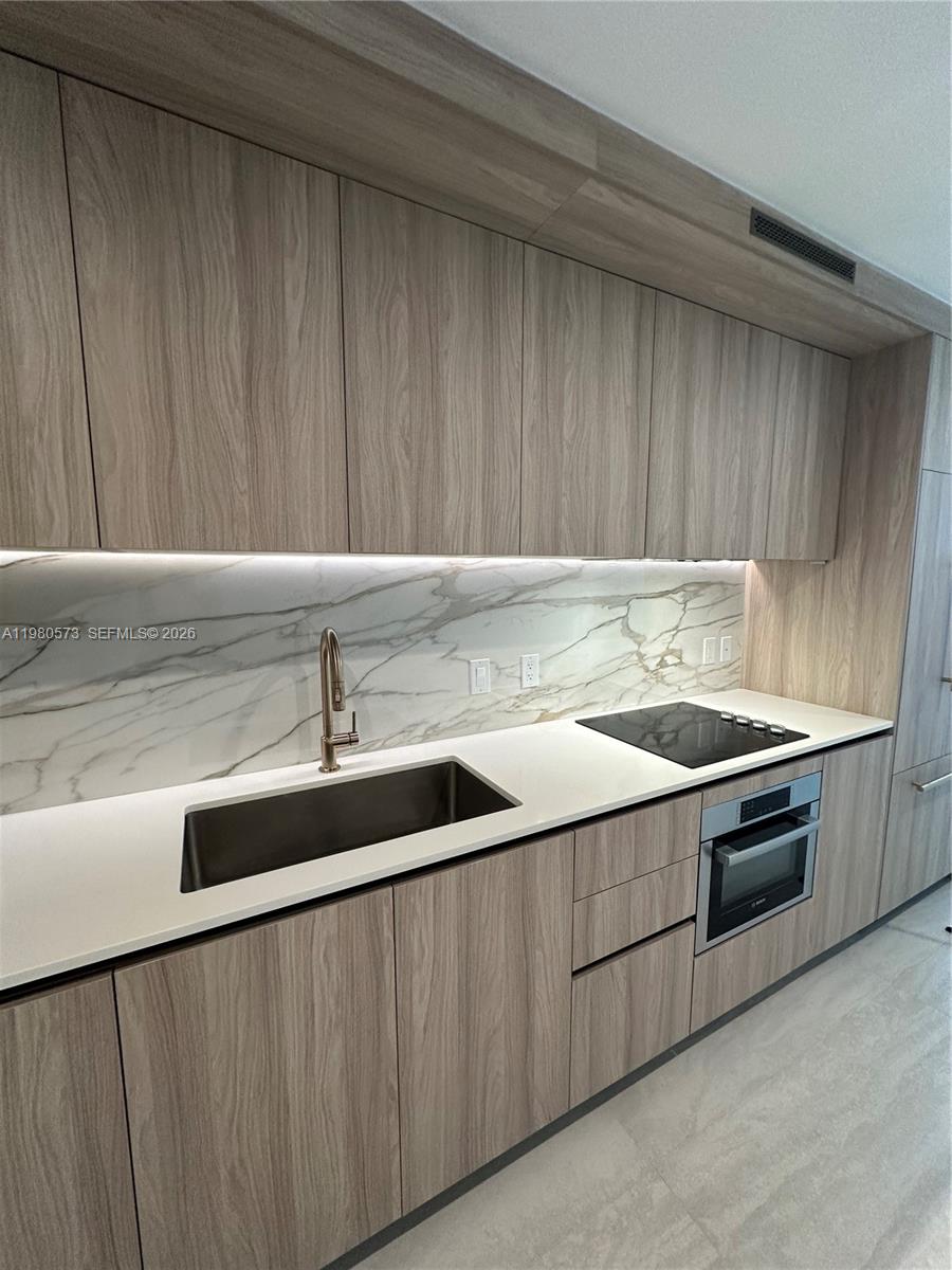a kitchen with a sink and cabinets