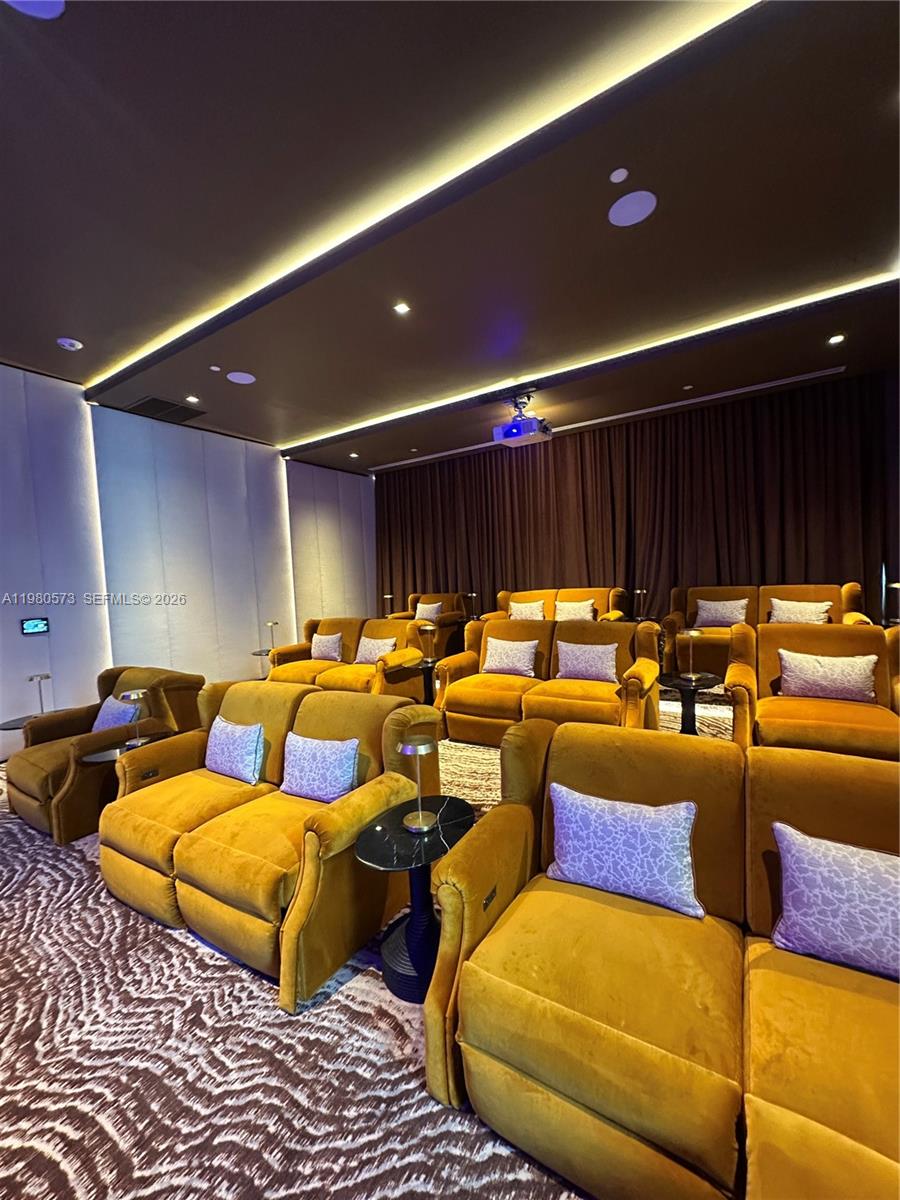 77 Southeast 5th Street, Unit 1514 Miami, FL 33131 - Photo 12 of 16 a media room with lots of chairs and a projector