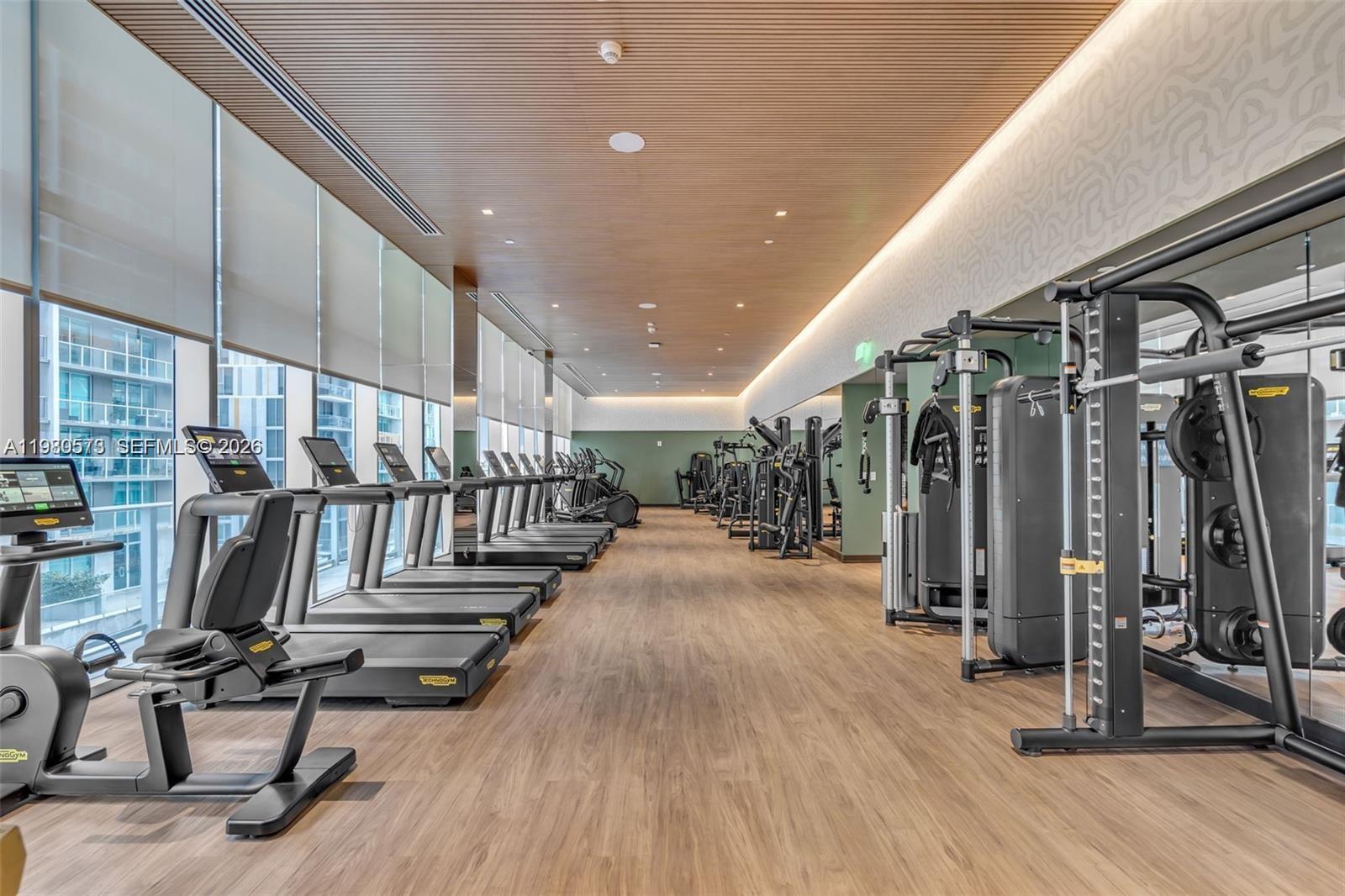 77 Southeast 5th Street, Unit 1514 Miami, FL 33131 - Photo 14 of 16 a view of a room with gym equipment