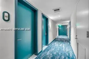a view of hallway with chandelier