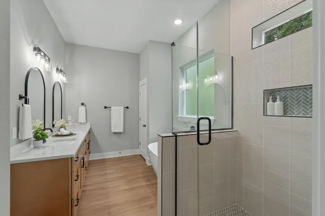 a bathroom with a granite countertop sink a toilet and with mirror