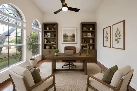 a view of a workspace with furniture and a window