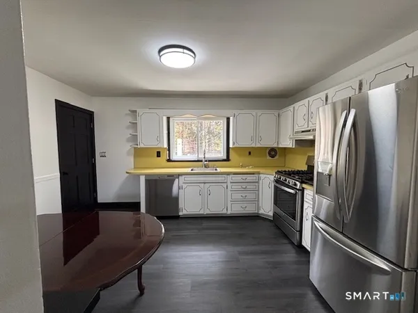 a kitchen with a refrigerator and a sink