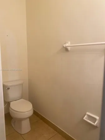 a bathroom with a white toilet and a shower