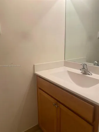 a bathroom with a sink and vanity