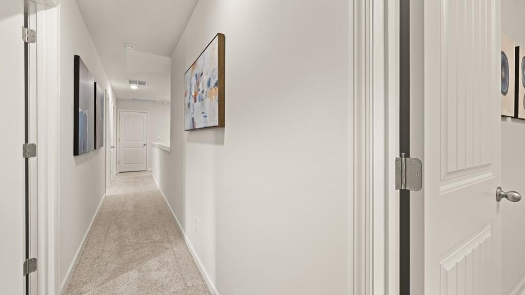 3869 Donetta Drive Atlanta, GA 30349 - Photo 27 of 49 a view of a hallway with paintings on the walls