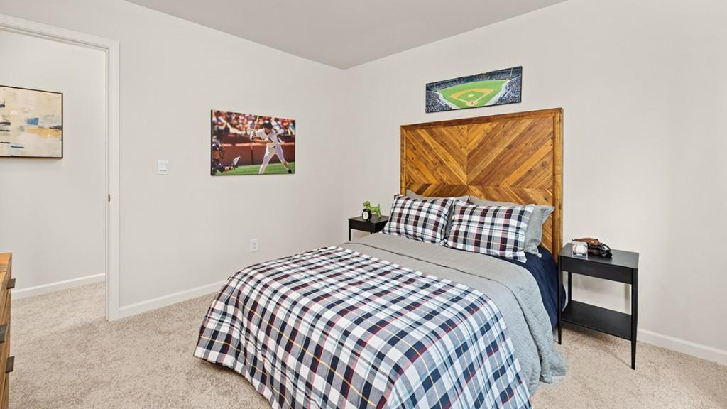 3869 Donetta Drive Atlanta, GA 30349 - Photo 31 of 49 a bedroom with a bed and a painting on the wall