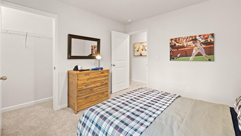 3869 Donetta Drive Atlanta, GA 30349 - Photo 32 of 49 a bedroom with a bed and painting on the wall