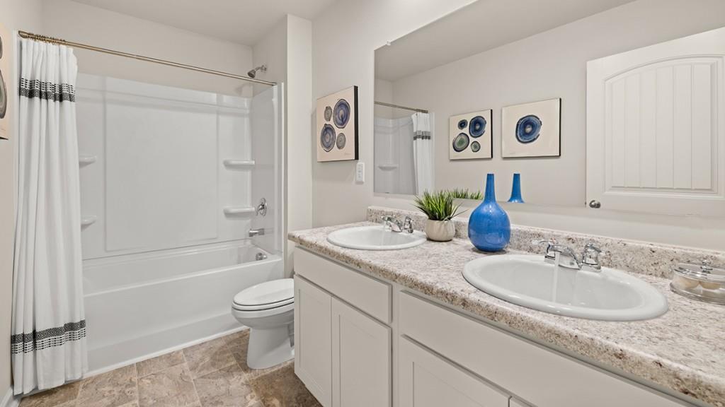 3869 Donetta Drive Atlanta, GA 30349 - Photo 37 of 49 a bathroom with a granite countertop sink toilet and shower