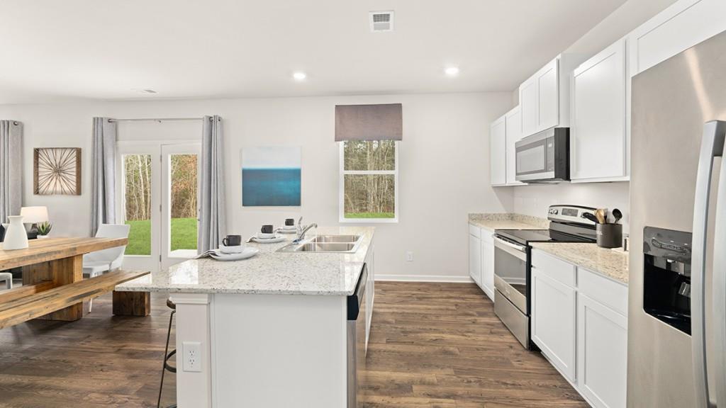 3869 Donetta Drive Atlanta, GA 30349 - Photo 5 of 49 a open kitchen with stainless steel appliances granite countertop a sink stove refrigerator and cabinets