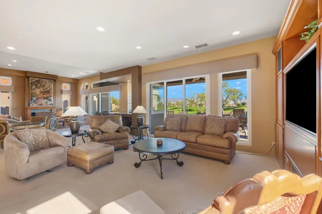a kitchen with kitchen island a large window appliances and furniture