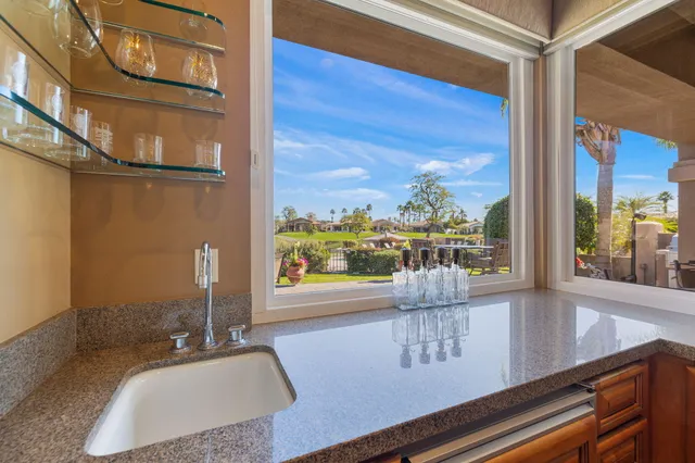 a living room with furniture a fireplace and a large mirror