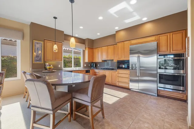 a living room with fireplace furniture and a large window