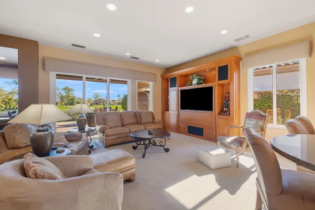 a dining room with furniture a chandelier and wooden floor