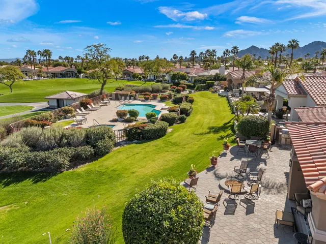 a view of swimming pool with outdoor seating and yard in back