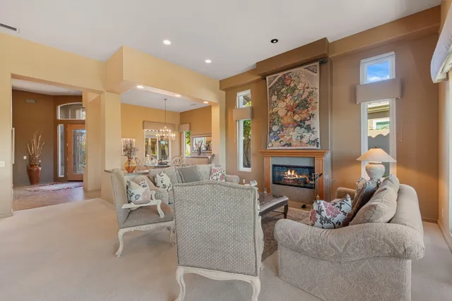 a view of a hallway with wooden floor and a bathroom