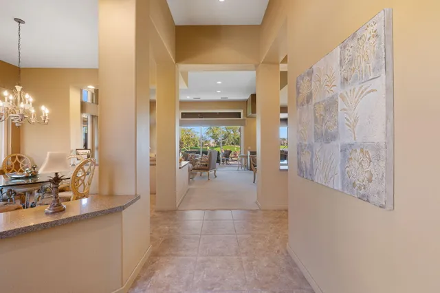 a living room with furniture a fireplace and a large window