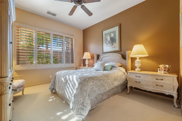a bathroom with a double vanity sink mirror and shower
