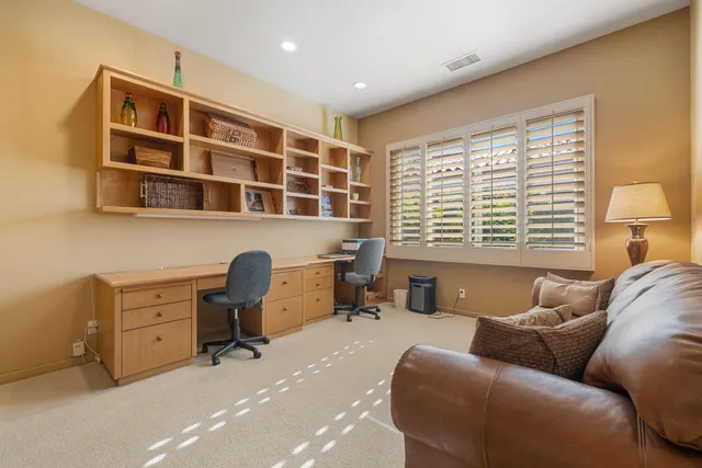 a view of a patio with dining table and chairs with plants and wooden fence